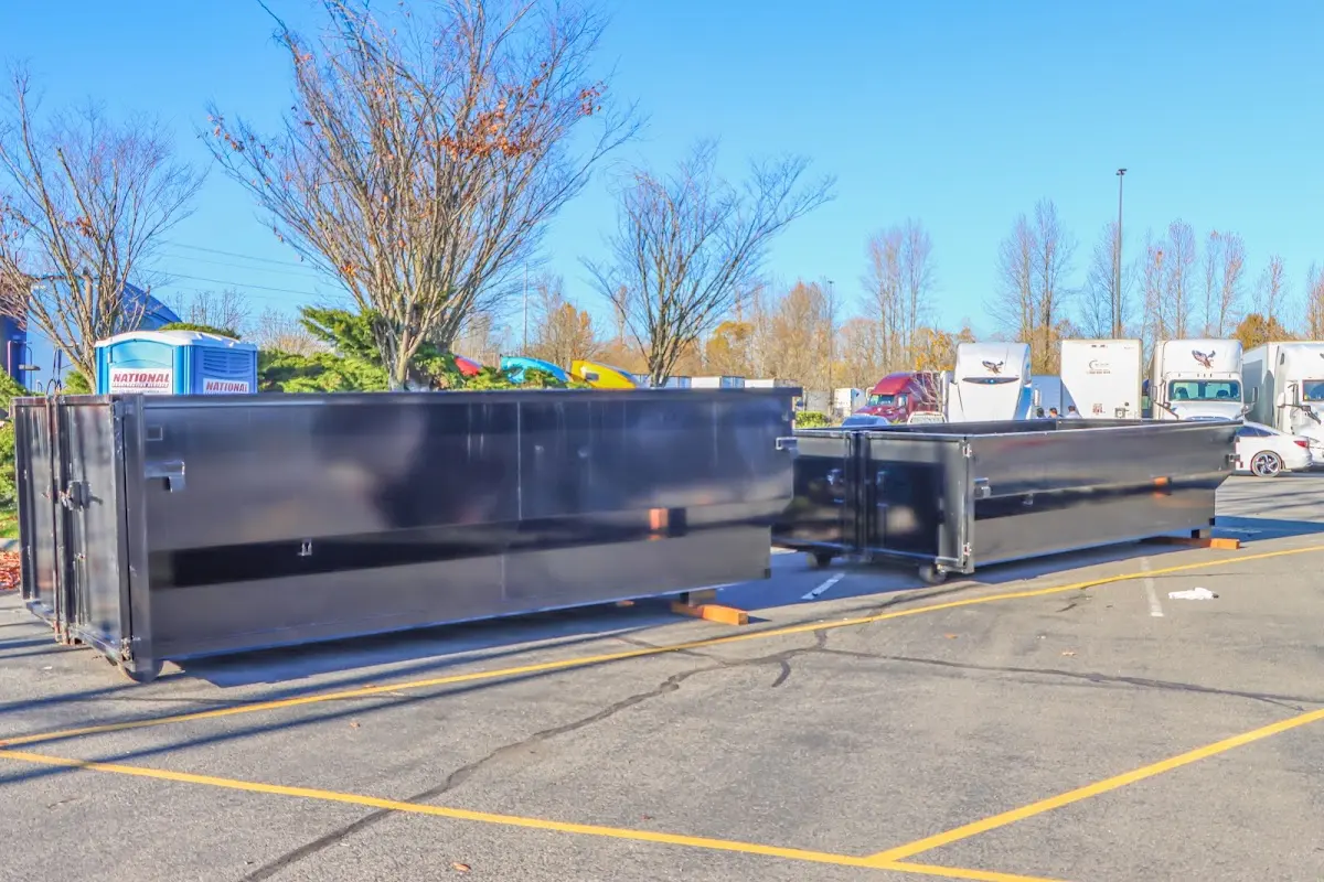 Professional dumpster rental service with roll-off container on residential driveway in Naples